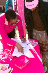 Volunteers provide counseling and share information about breast cancer at a booth in Zandspruit, South Africa. Photo by Anna J Nel