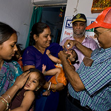 Volunteers immunize a child in India during a National Immunization Day in 2008. Alyce Henson/Rotary International