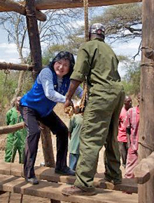 Michiko Mitarai shows Ugandan villagers a Japanese method for drawing water from a well.