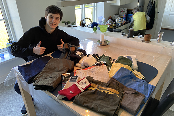Artem Ziablov looks over his new clothes, courtesy of a merchant in Denmark.